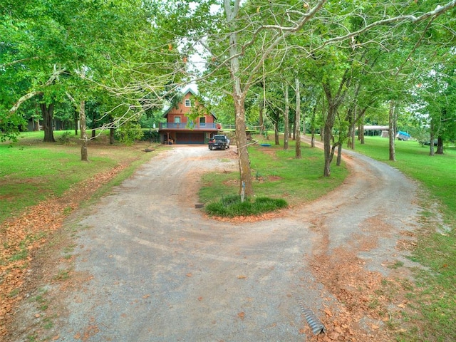 view of front of house with a wooden deck and a front yard