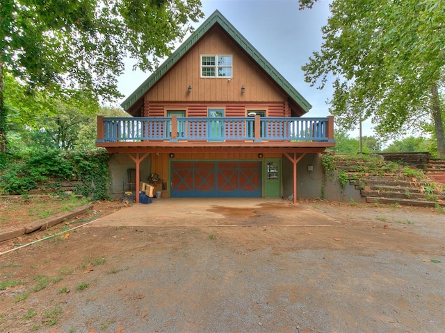 cabin featuring a deck and a garage