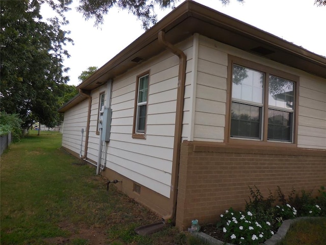 view of side of home featuring a yard