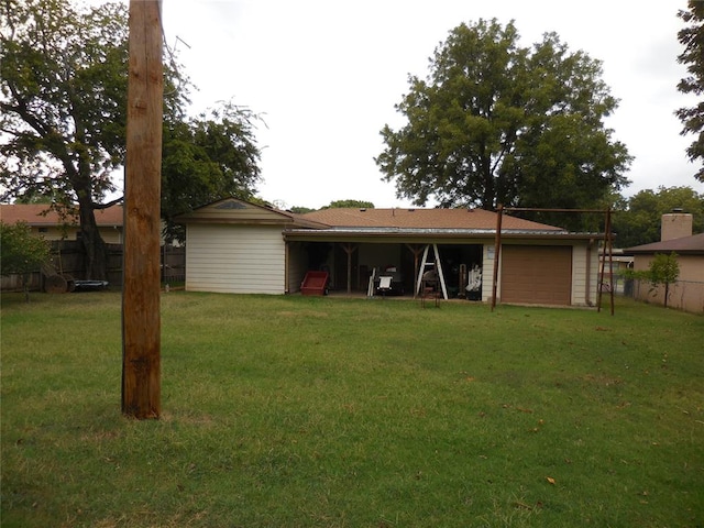 back of house featuring a yard