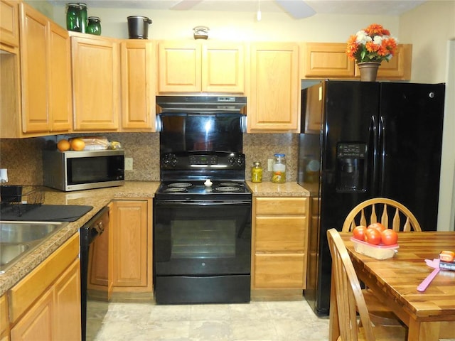 kitchen featuring backsplash, light brown cabinetry, light tile patterned floors, and black appliances