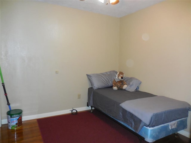 bedroom with dark hardwood / wood-style floors and ceiling fan