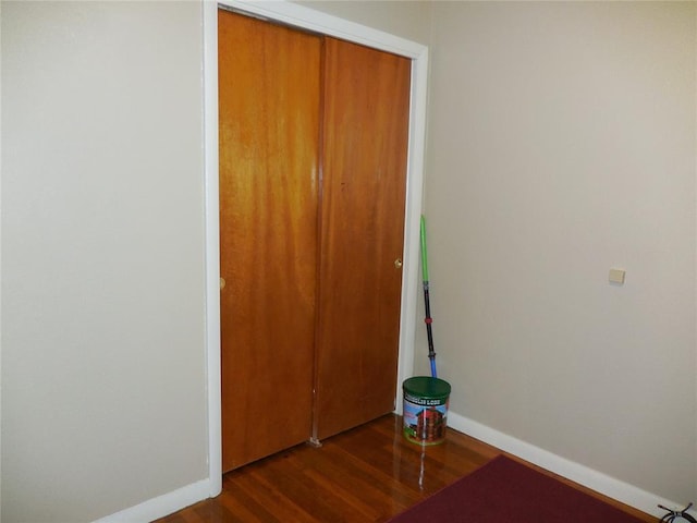 unfurnished bedroom featuring dark hardwood / wood-style floors and a closet