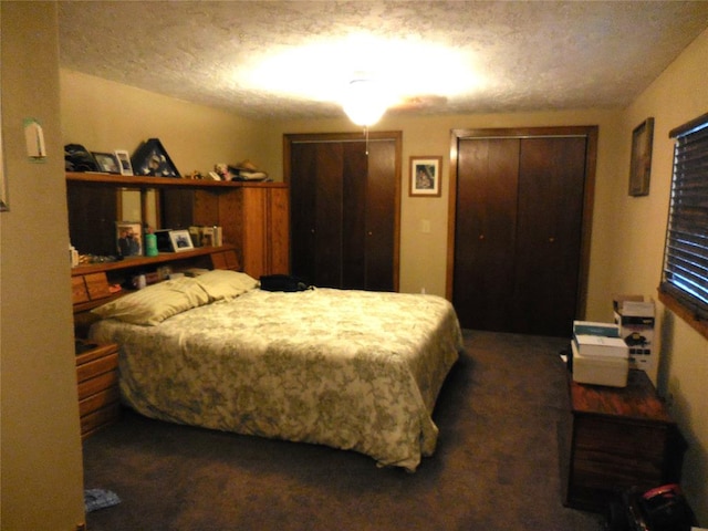 bedroom featuring dark carpet and a textured ceiling