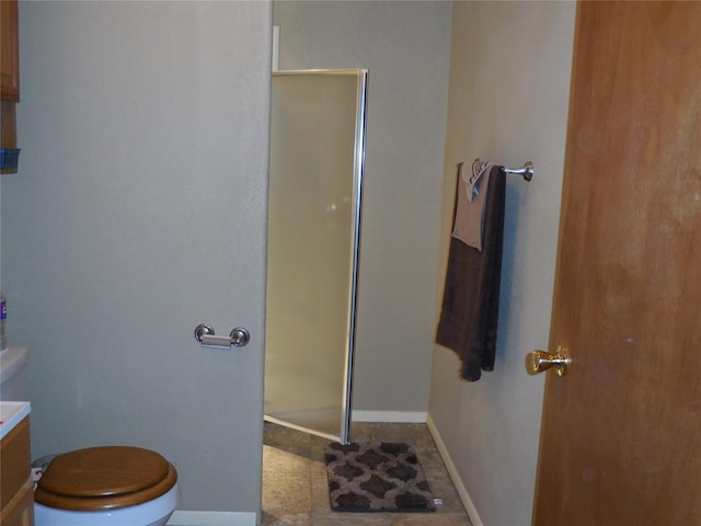 bathroom with vanity, toilet, and walk in shower