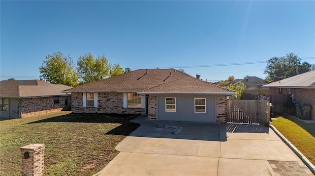 ranch-style house featuring a patio area and a front lawn