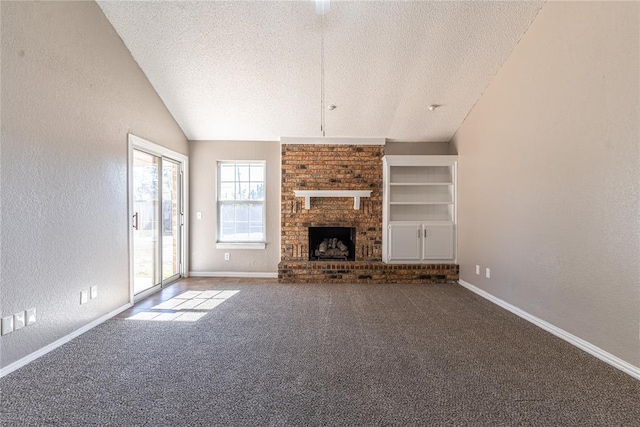 unfurnished living room with a textured ceiling, built in shelves, a fireplace, and lofted ceiling