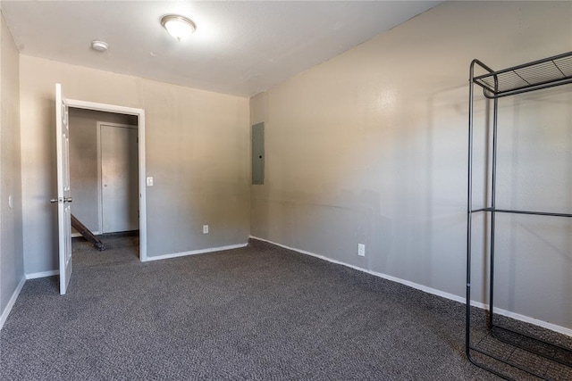 unfurnished bedroom featuring dark carpet and electric panel