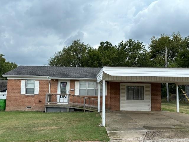 single story home featuring a carport and a front lawn