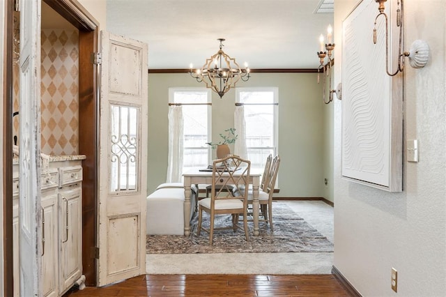 dining area with wood-type flooring, ornamental molding, and a wealth of natural light