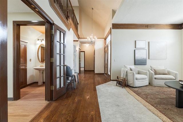 interior space with a chandelier, dark hardwood / wood-style floors, and lofted ceiling