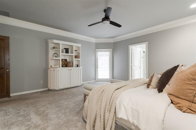 carpeted bedroom featuring ceiling fan and crown molding