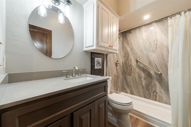 bathroom with a shower with shower curtain, wood-type flooring, vanity, and toilet