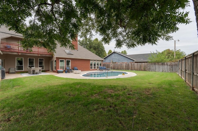 view of yard with a fenced in pool and a patio area