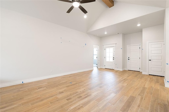 unfurnished living room with ceiling fan, high vaulted ceiling, baseboards, light wood-style floors, and beam ceiling