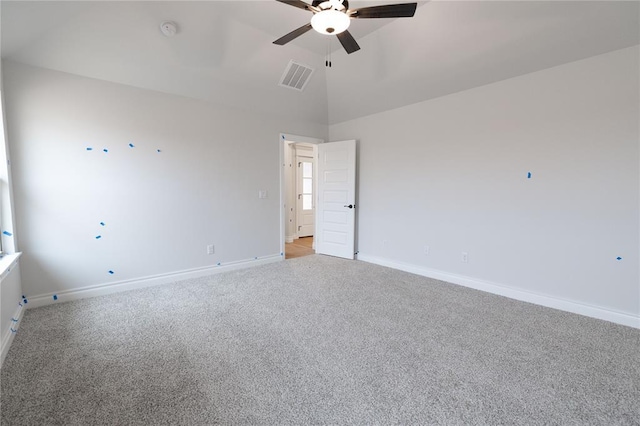 empty room with ceiling fan, light colored carpet, visible vents, baseboards, and vaulted ceiling