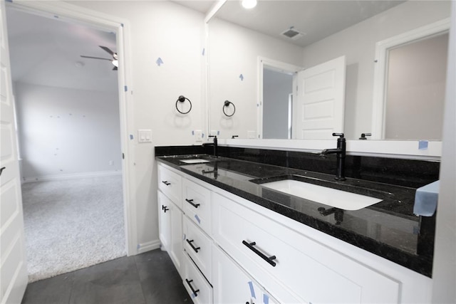 full bathroom with double vanity, a sink, visible vents, and baseboards