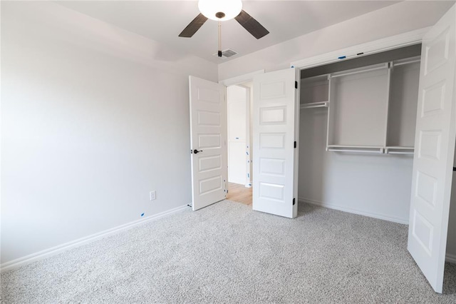 unfurnished bedroom featuring visible vents, baseboards, ceiling fan, carpet, and a closet