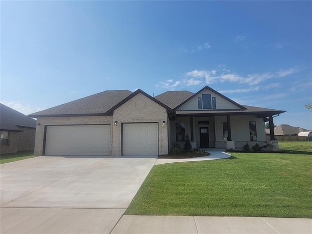 view of front of property with a porch, a garage, and a front yard