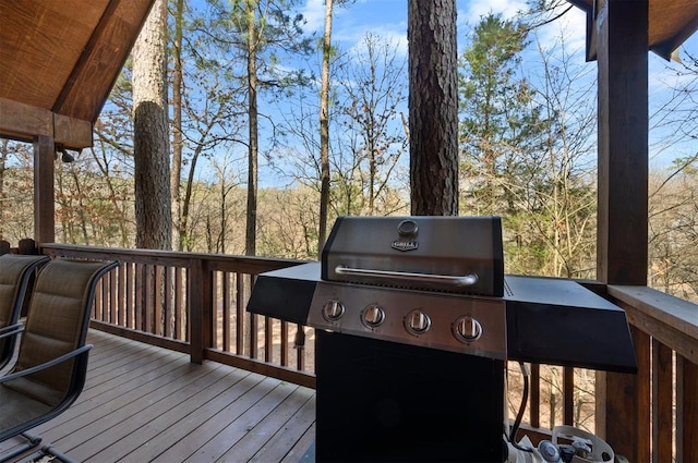 wooden deck featuring a grill