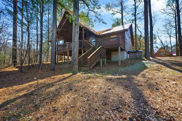 back of property featuring a wooden deck