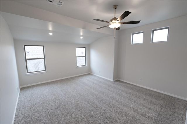 unfurnished room with vaulted ceiling, light colored carpet, and ceiling fan