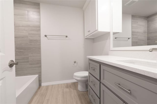 bathroom featuring hardwood / wood-style flooring, vanity, and toilet