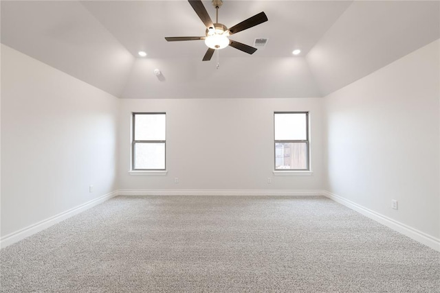 carpeted spare room featuring ceiling fan and lofted ceiling