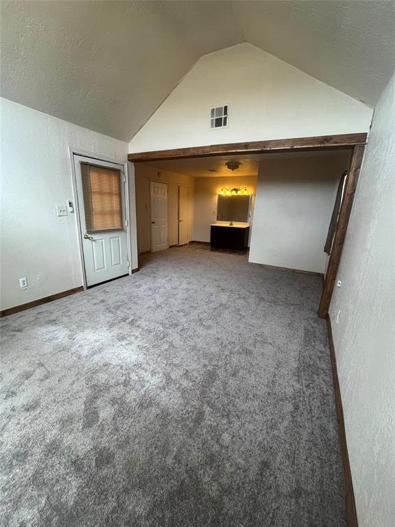 interior space featuring carpet flooring and lofted ceiling