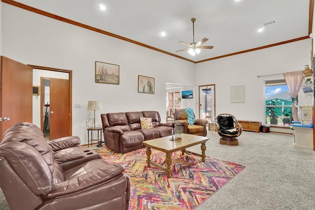 living room with a towering ceiling, carpet floors, ceiling fan, and ornamental molding