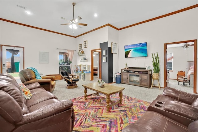 living room with ceiling fan, light colored carpet, and ornamental molding