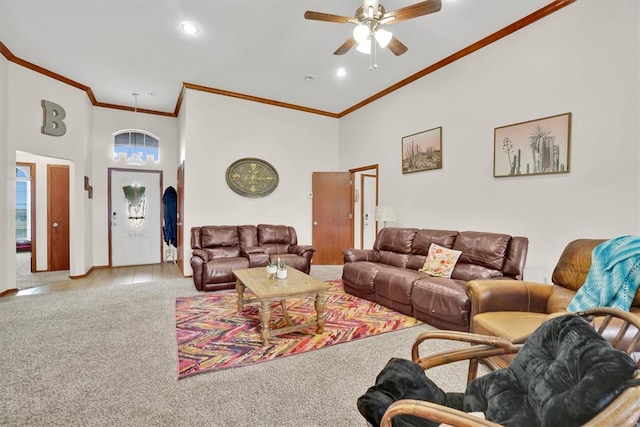 carpeted living room with ceiling fan, crown molding, and a high ceiling