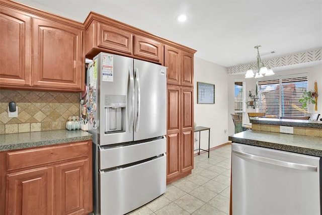 kitchen featuring stainless steel appliances, a notable chandelier, backsplash, decorative light fixtures, and light tile patterned flooring