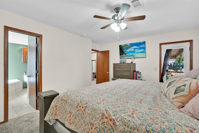 tiled bedroom featuring ceiling fan and ensuite bath