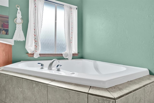 bathroom with tiled bath