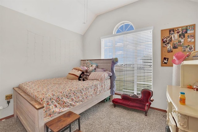 carpeted bedroom with lofted ceiling