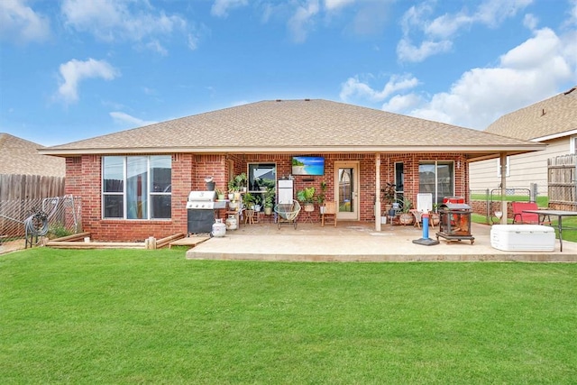 back of property featuring a yard and a patio area