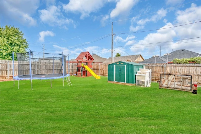 view of yard with a trampoline, a playground, and a shed