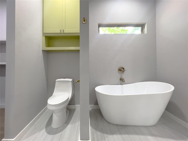 bathroom featuring toilet and a tub