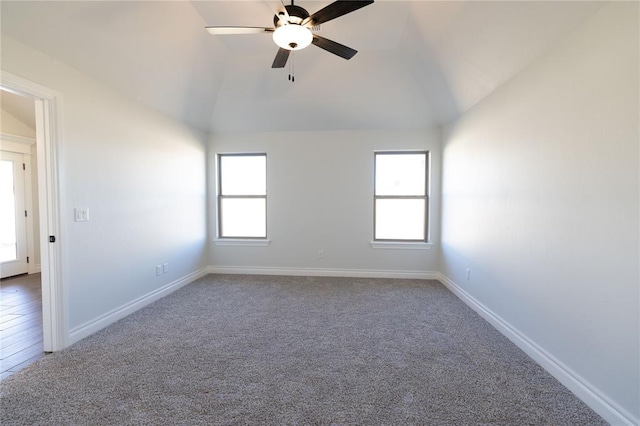 carpeted spare room featuring ceiling fan and lofted ceiling