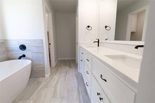 bathroom with vanity and a tub