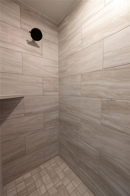 bathroom with a tile shower