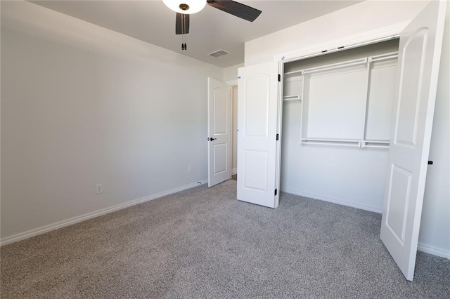 unfurnished bedroom with ceiling fan, light colored carpet, and a closet