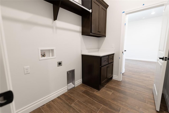 washroom featuring washer hookup, electric dryer hookup, and cabinets