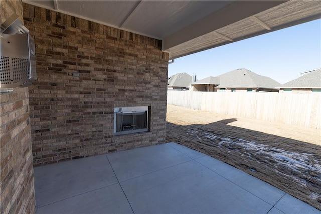 view of patio featuring an outdoor brick fireplace