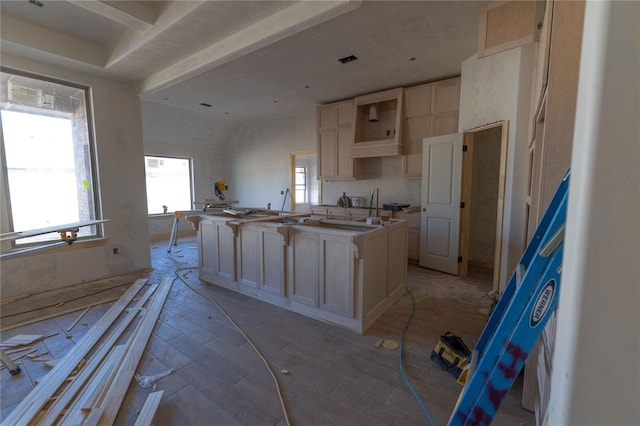 kitchen featuring light brown cabinetry and a center island