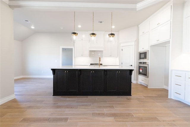 kitchen featuring white cabinets, dark cabinetry, stainless steel oven, and built in microwave