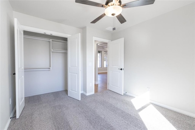 unfurnished bedroom featuring carpet, baseboards, ceiling fan, and a closet