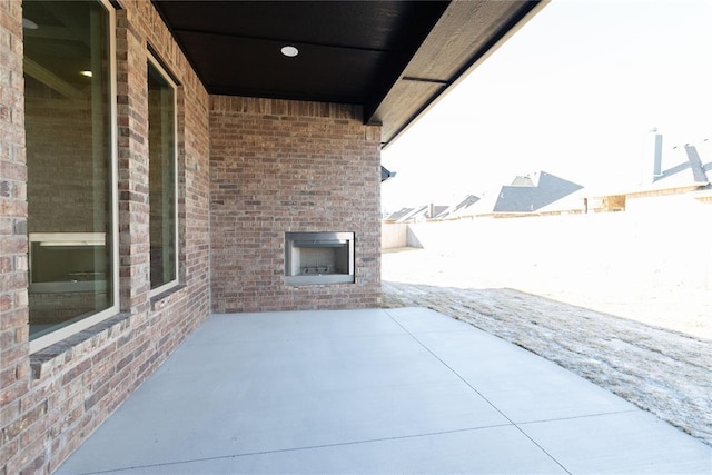 view of patio featuring an outdoor brick fireplace