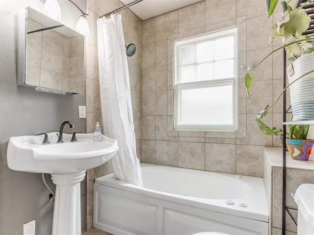 bathroom featuring shower / tub combo with curtain and a healthy amount of sunlight